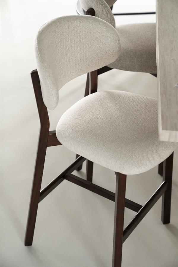 Barkruk Mikky beige stof bruin eikenhout in een interieur